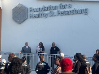 Pastor Clarence Williams gives the invocation