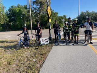 Riders at halfway marker "Ride to Eliminate Health Gaps"